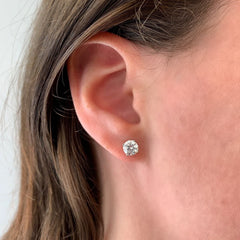 model wearing 4 prong basket setting natural diamond studs